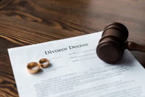 Divorce document with rings and judge’s gavel representing paperwork assistance in Tampa / Documento de divorcio con anillos y mazo de juez representando asistencia con trámites en Tampa